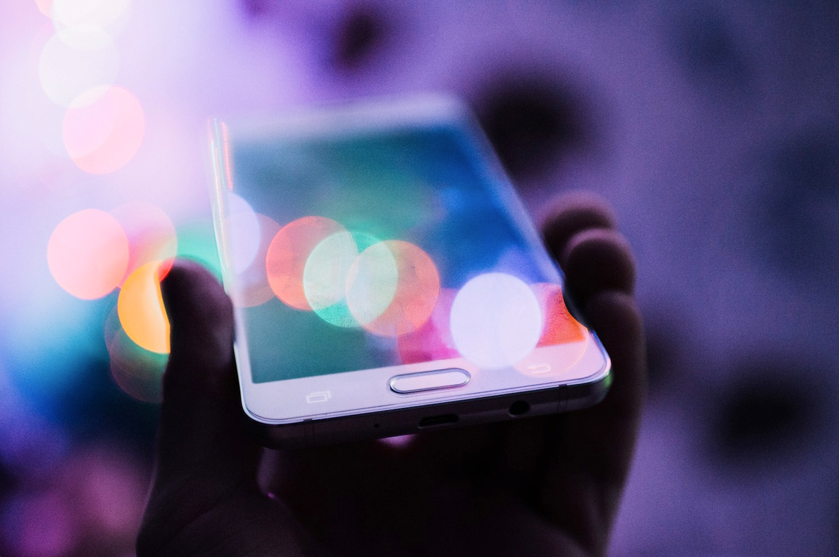 a held cellphone with pretty lens flare